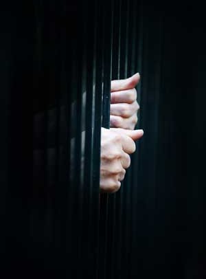 prison-bars-female-hands